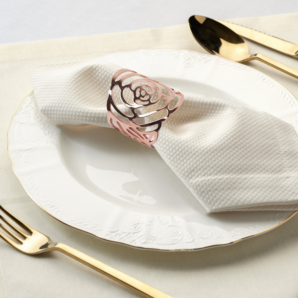 https://cdn.shopify.com/s/files/1/0042/0390/5136/files/Laser-Cut-Rose-Metal-Napkin-Ring-Rose-Gold-environmental-1_1.jpg?v=1767714982