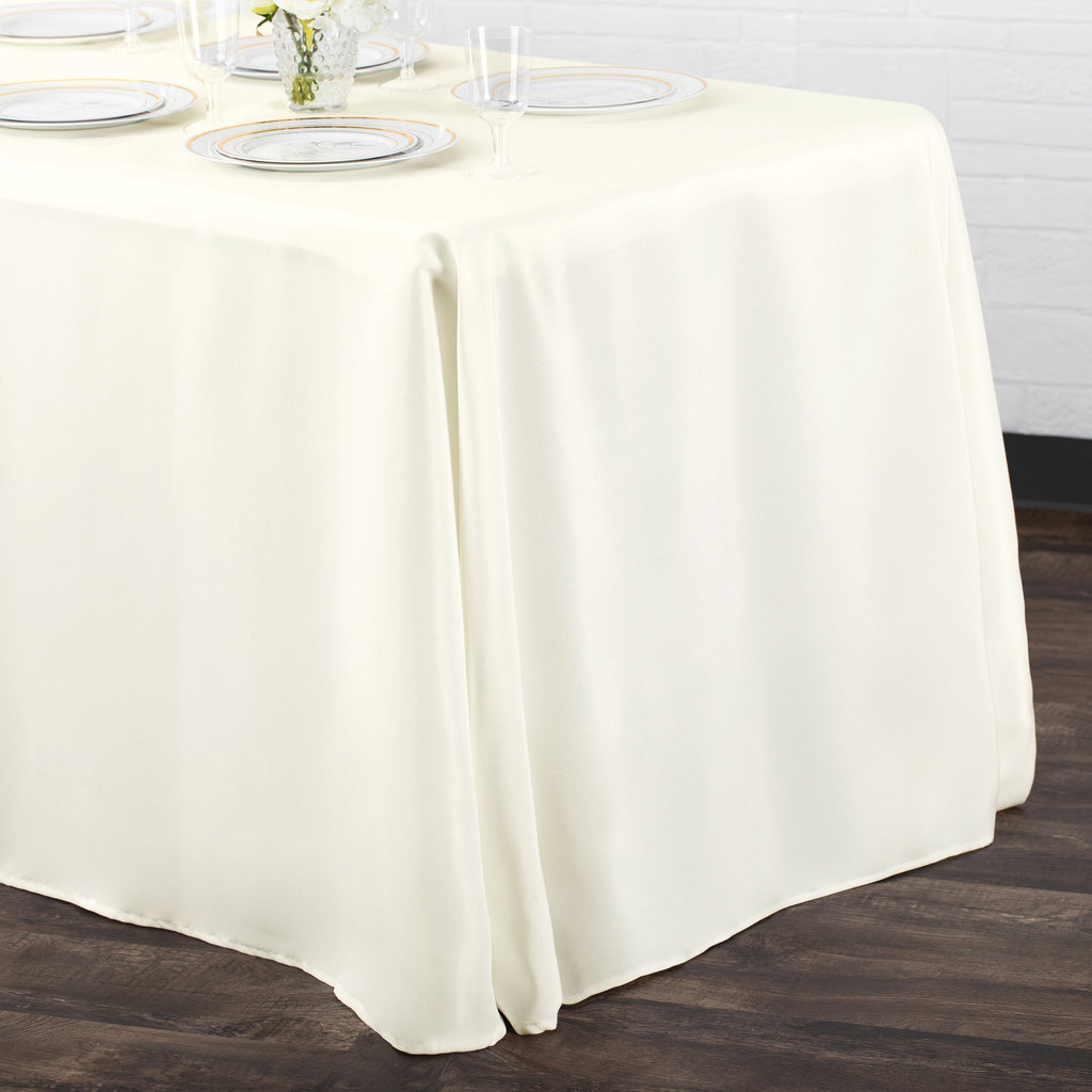 https://cdn.shopify.com/s/files/1/0042/0390/5136/products/Polyester-Rectangular-Tablecloth-Light-Ivory-Off-White-Env.jpg?v=1773895630
