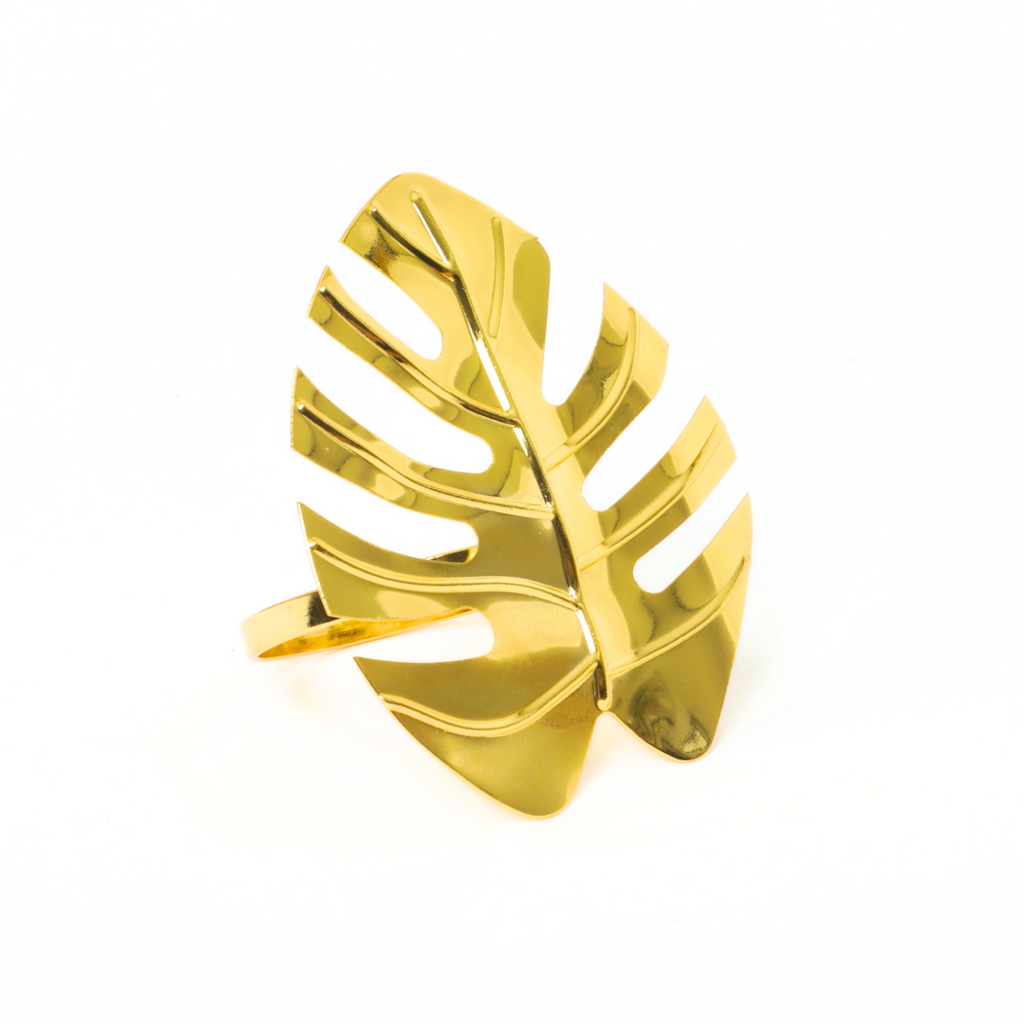 https://cdn.shopify.com/s/files/1/0042/0390/5136/files/gold-monstera-leaf-napkin-ring1.png?v=1772119848