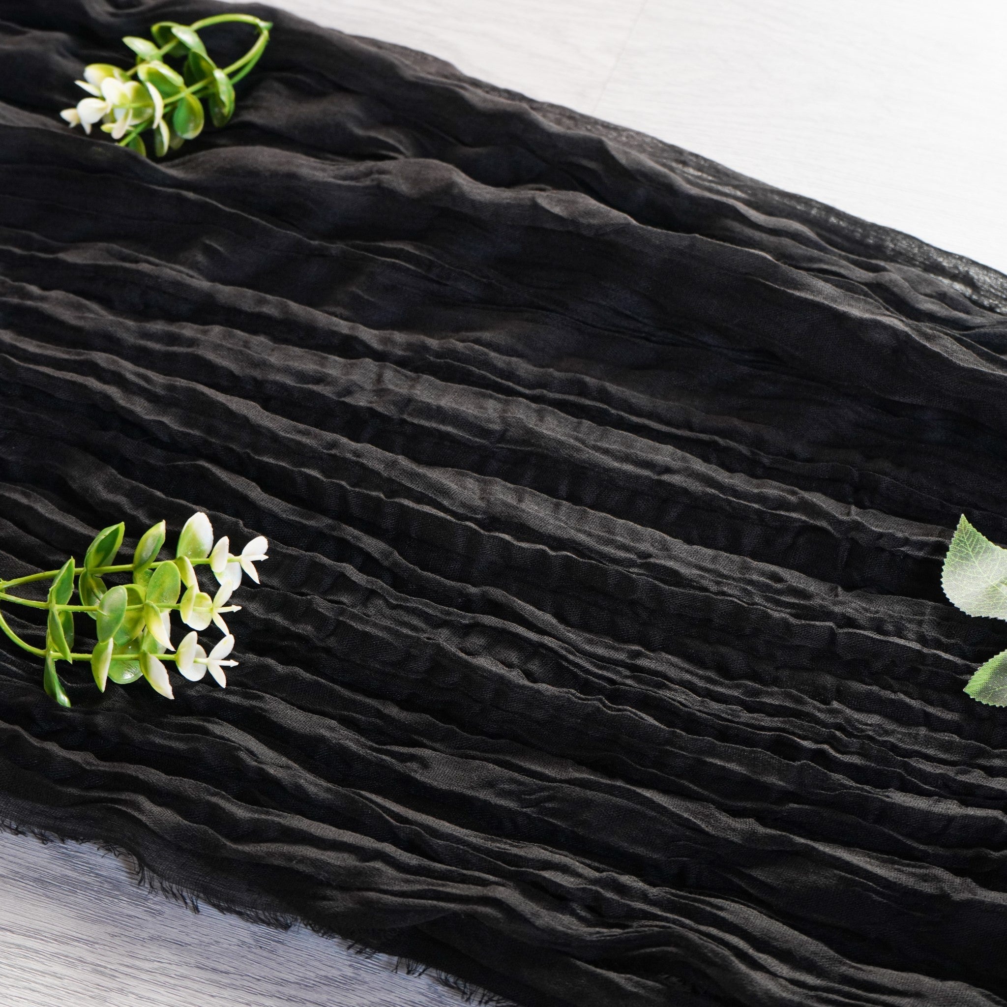 https://cdn.shopify.com/s/files/1/0042/0390/5136/products/premium-cheesecloth-table-runner-black3.jpg?v=1744687553